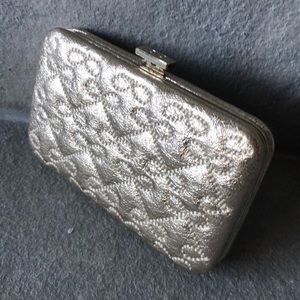 Designer Anya Hindmarch card holder in gold.